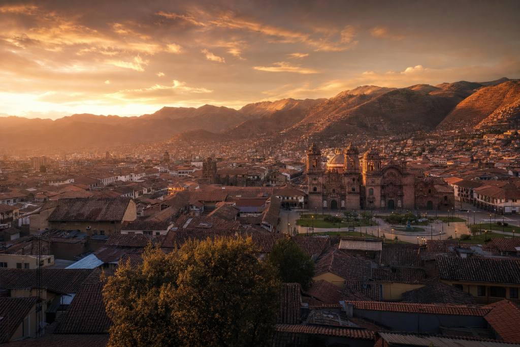 Cusco skyline at golden hour with iconic landmarks in warm light