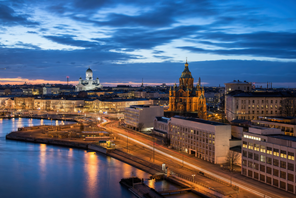 Helsinki high-vantage cityscape at blue hour with city lights and traffic motion