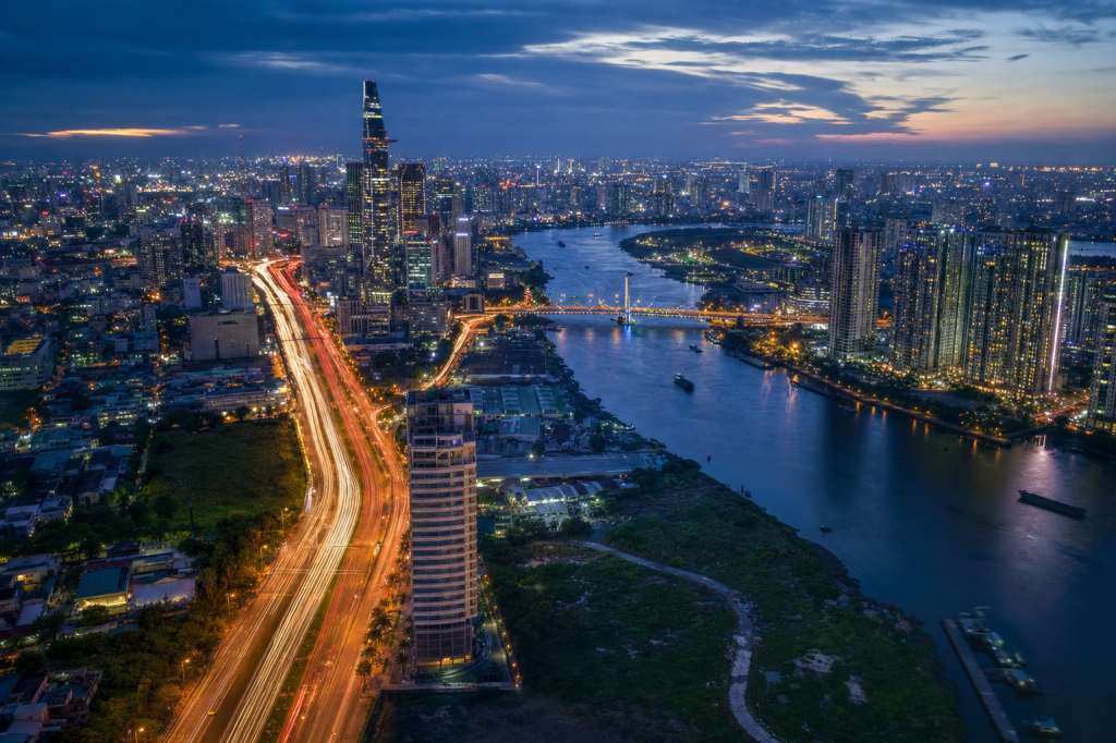 Ho Chi Minh City high-vantage cityscape at blue hour with city lights and traffic motion