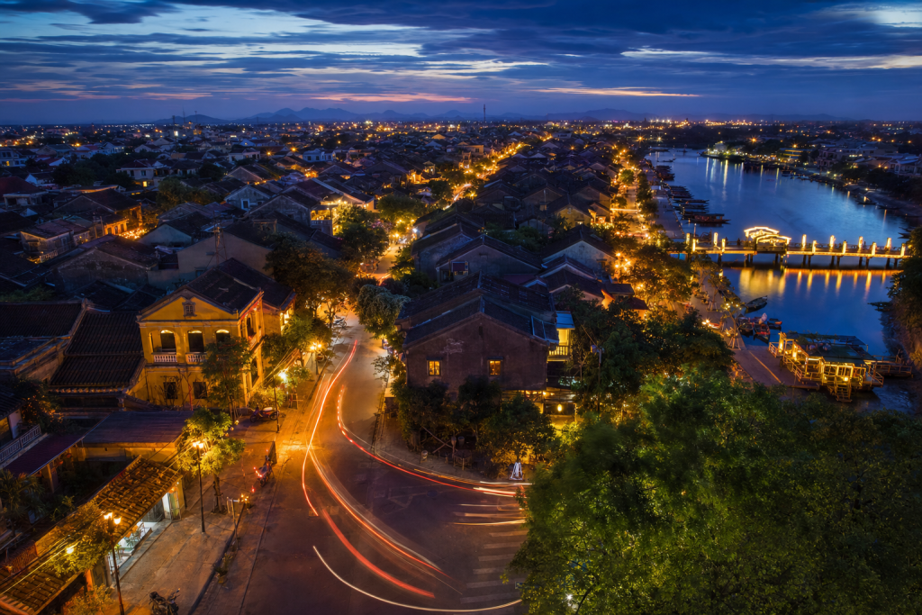 Hoi An high-vantage cityscape at blue hour with city lights and traffic motion