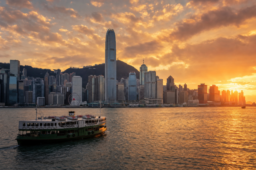Hong Kong skyline at golden hour with iconic landmarks in warm light