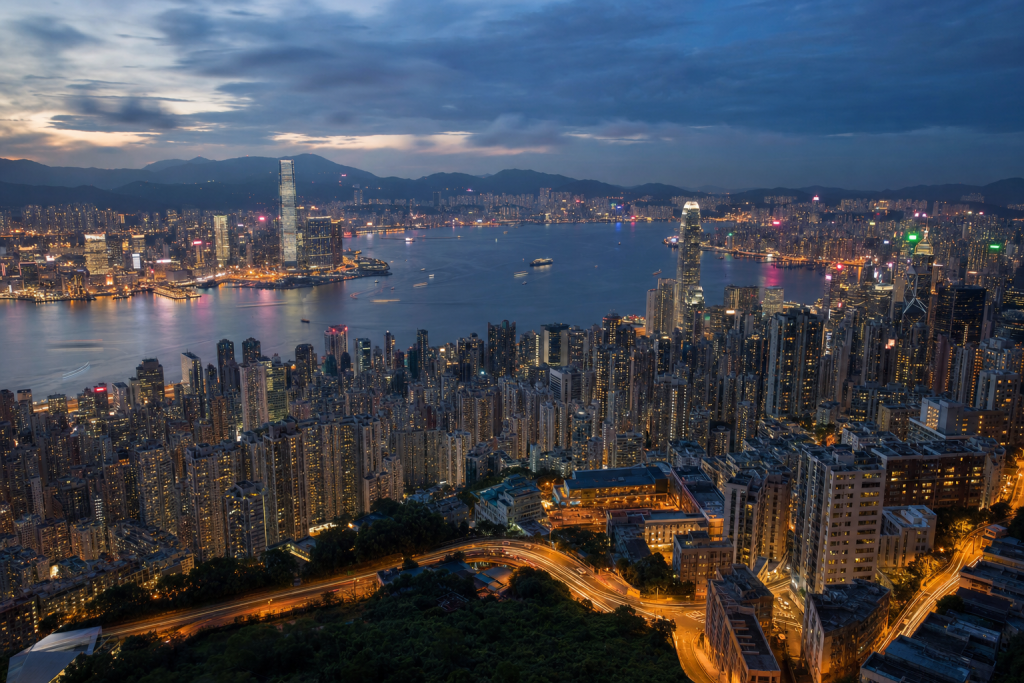 Hong Kong high-vantage cityscape at blue hour with city lights and traffic motion