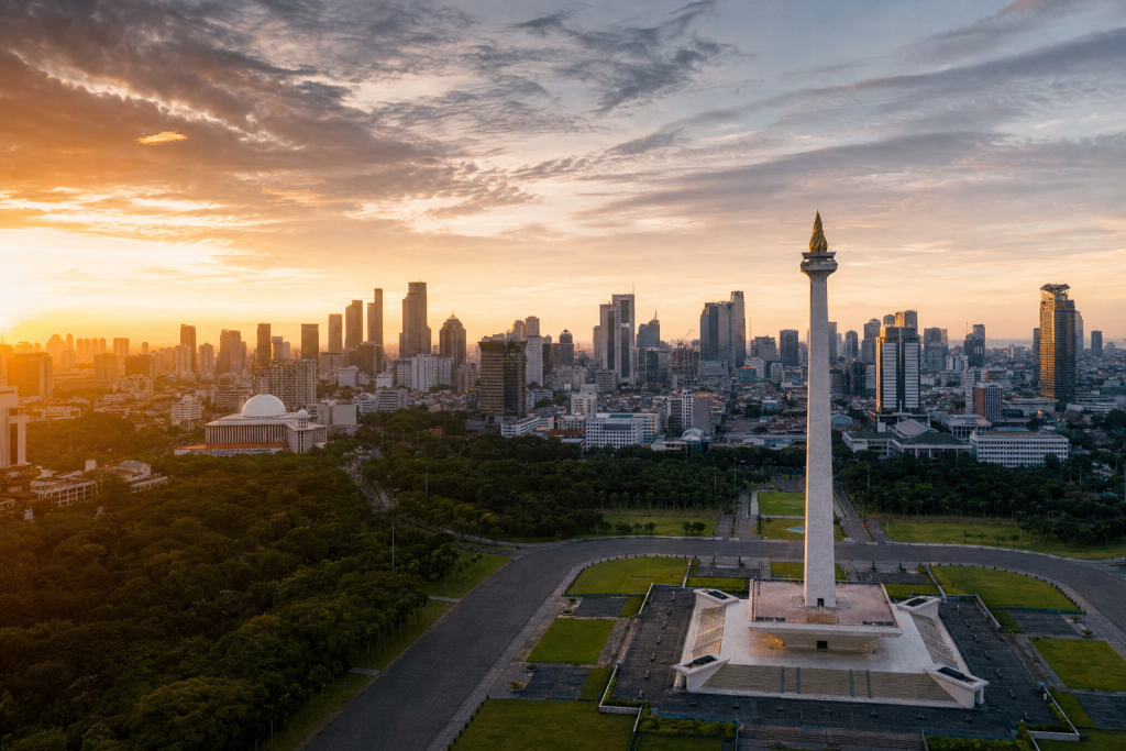 Jakarta skyline at golden hour with iconic landmarks in warm light