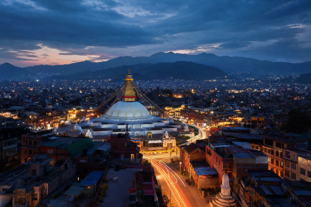 Kathmandu high-vantage cityscape at blue hour with city lights and traffic motion