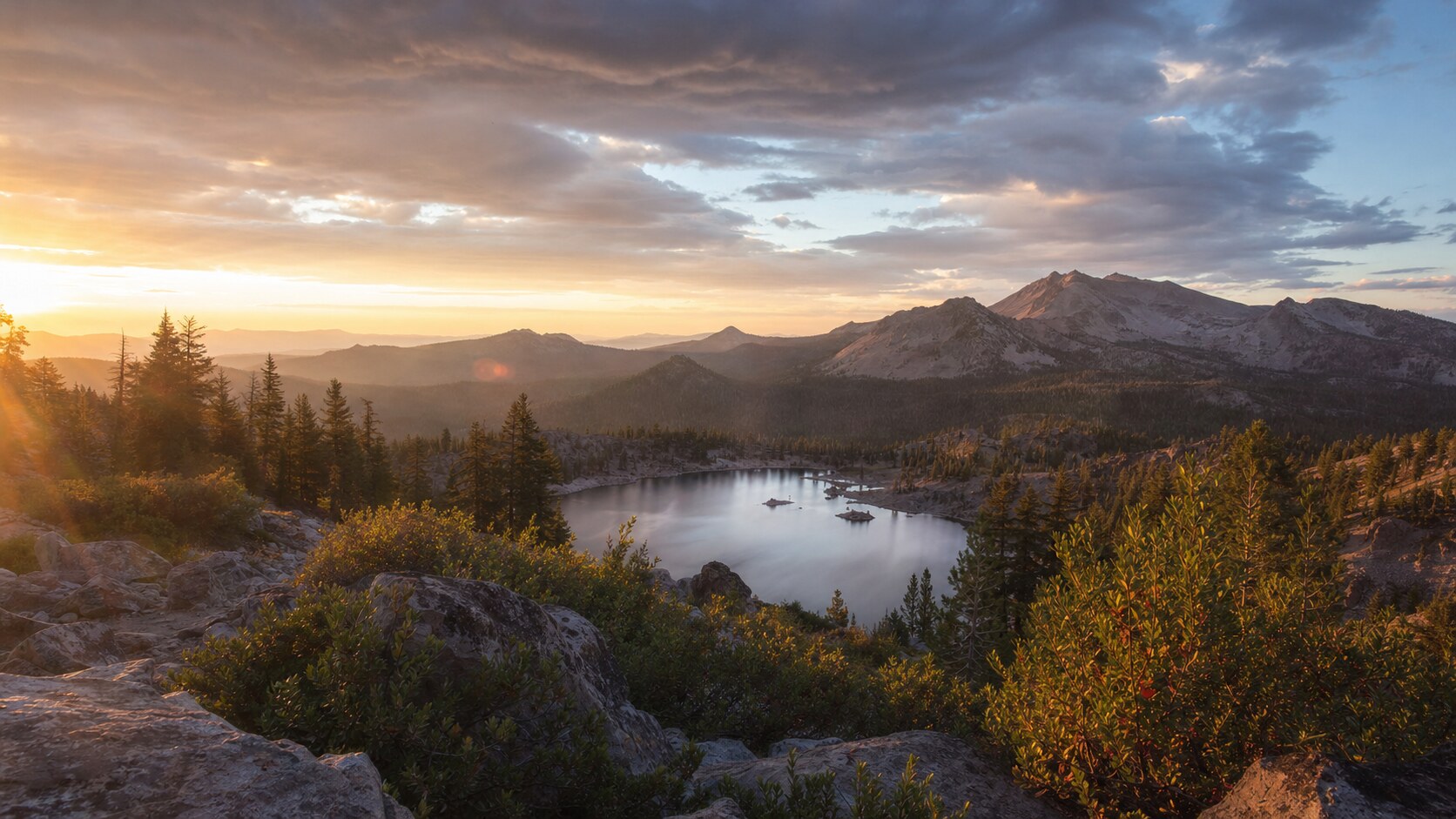 Sunrise landscape photograph at Lassen Volcanic National Park from the most popular sunrise overlook, showing the signature foreground-to-background composition