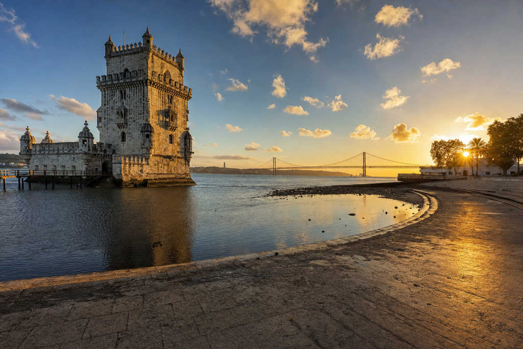 Wide-angle cinematic skyline of Lisbon at golden hour, iconic landmarks visible, dramatic warm light