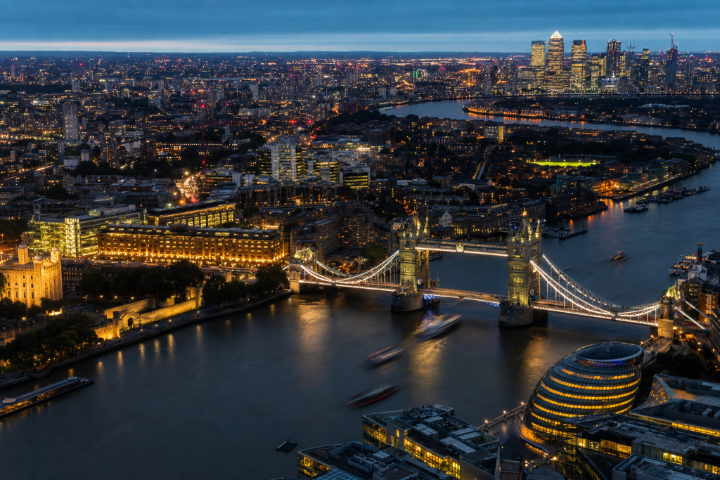 London high-vantage cityscape at blue hour with city lights and traffic motion