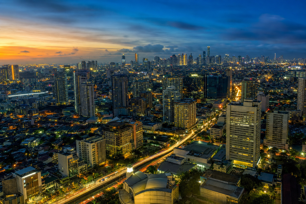 Manila high-vantage cityscape at blue hour with city lights and traffic motion