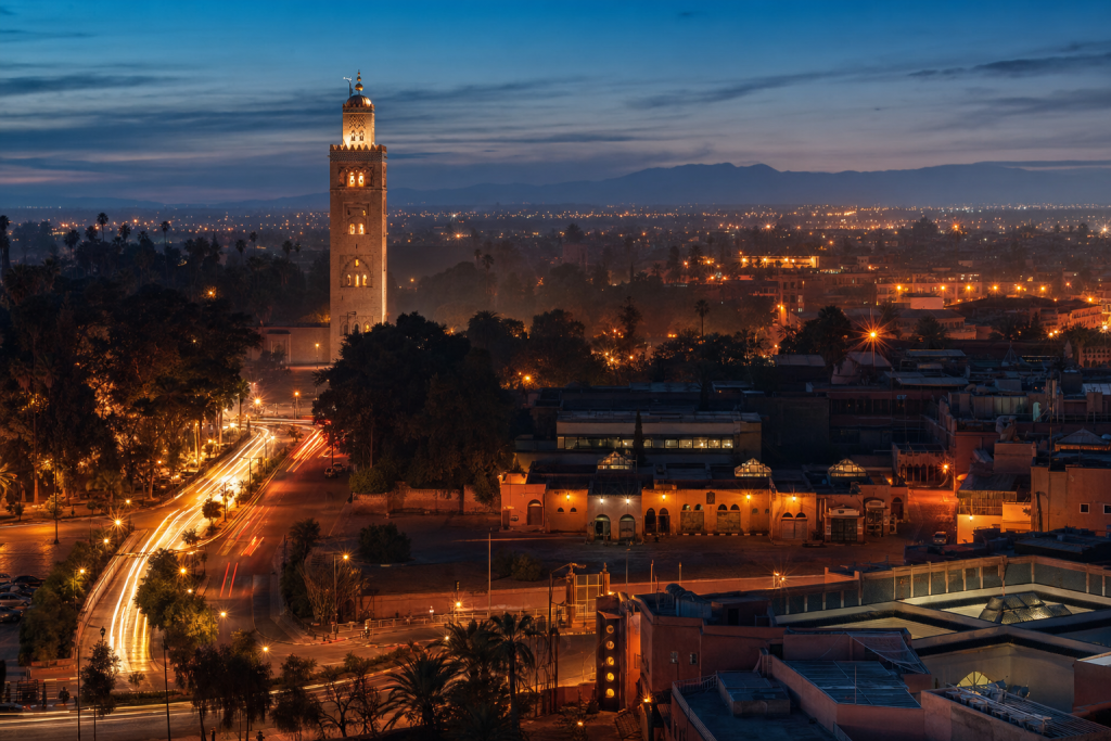 Marrakech high-vantage cityscape at blue hour with city lights and traffic motion