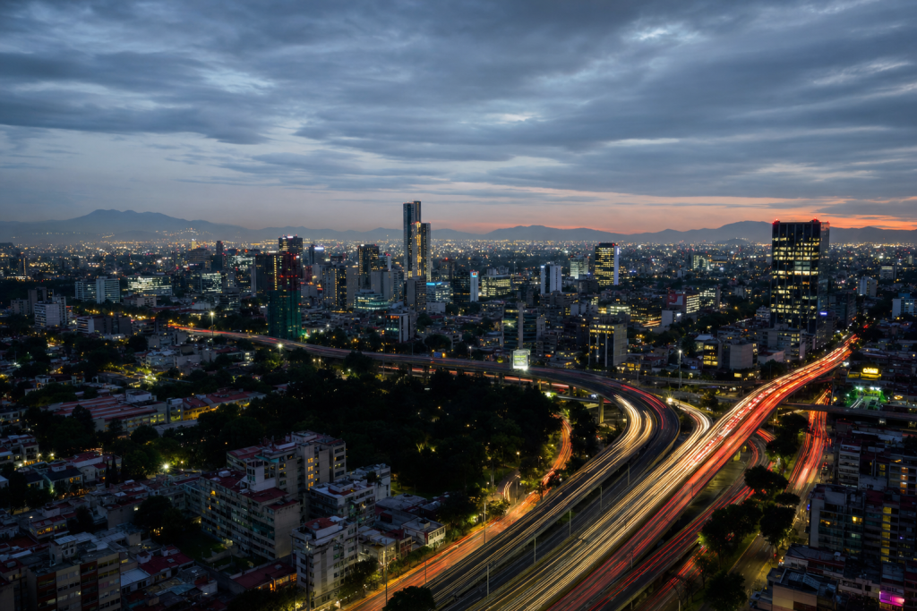 Mexico City high-vantage cityscape at blue hour with city lights and traffic motion