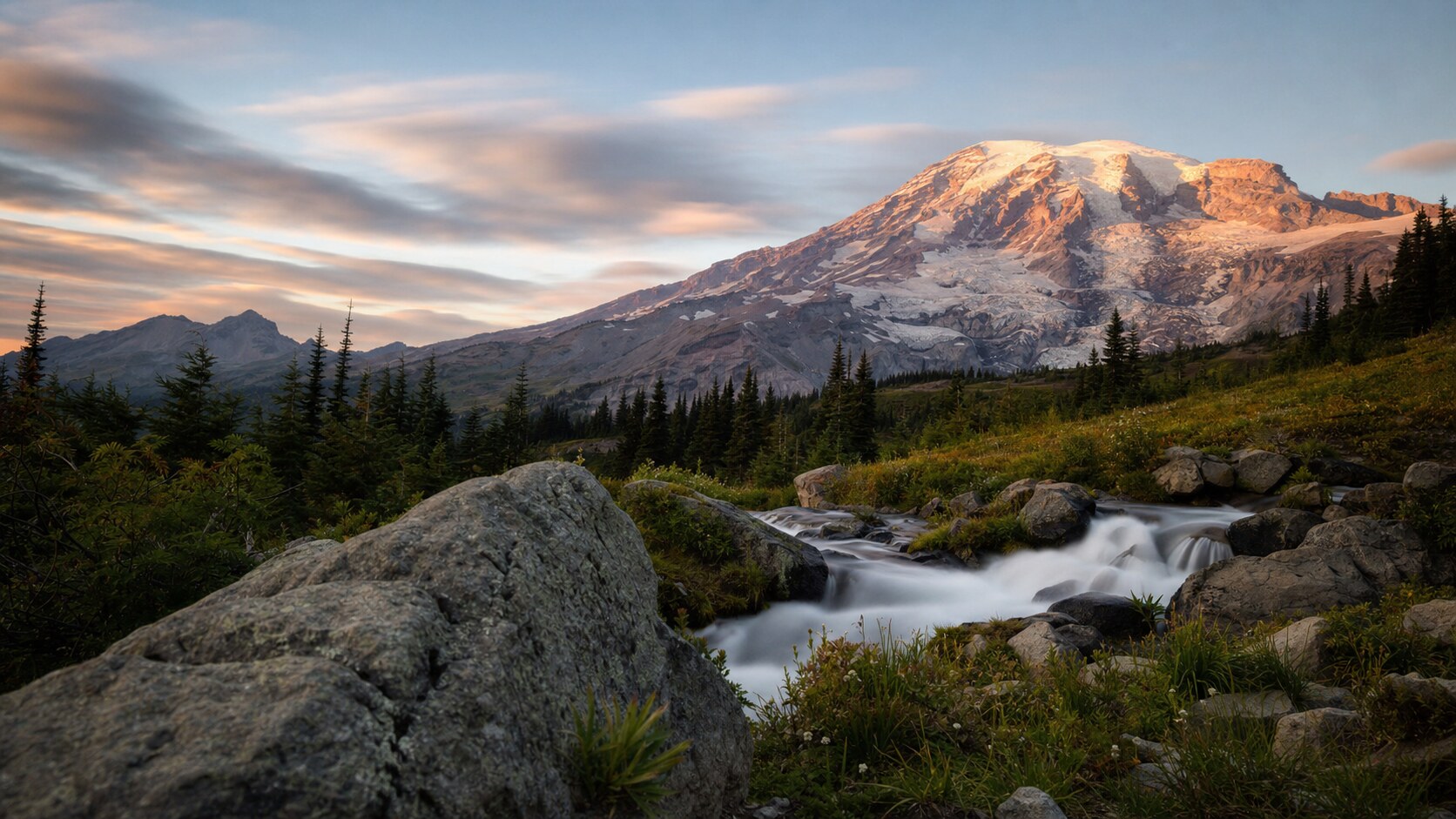Sunrise landscape photograph at Mount Rainier National Park from the most popular sunrise overlook, showing the signature foreground-to-background composition