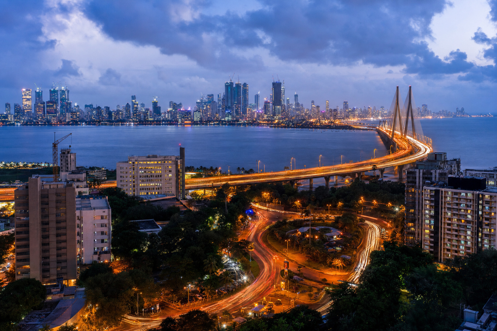 Mumbai high-vantage cityscape at blue hour with city lights and traffic motion
