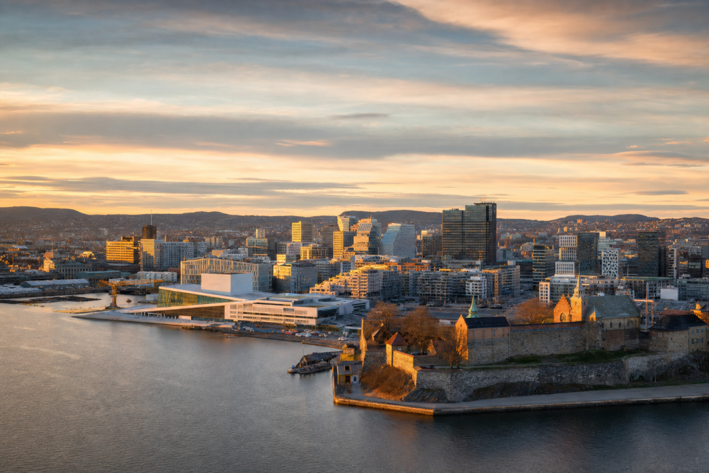 Oslo skyline at golden hour with iconic landmarks in warm light