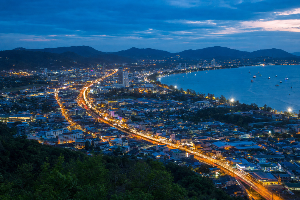 Phuket high-vantage cityscape at blue hour with city lights and traffic motion