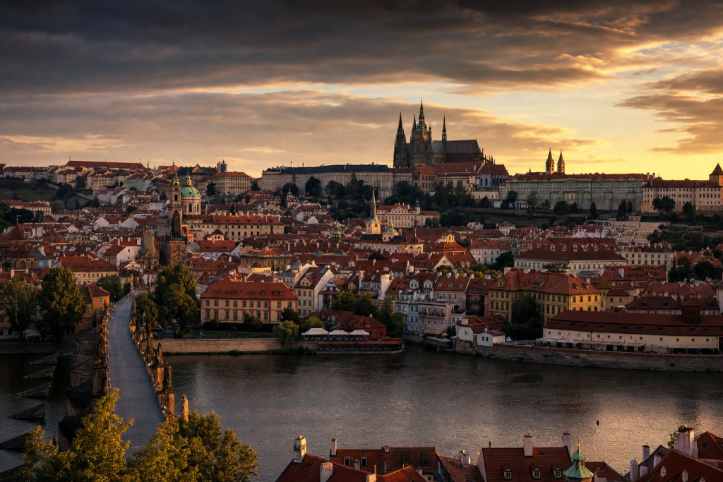 Prague skyline at golden hour with iconic landmarks in warm light