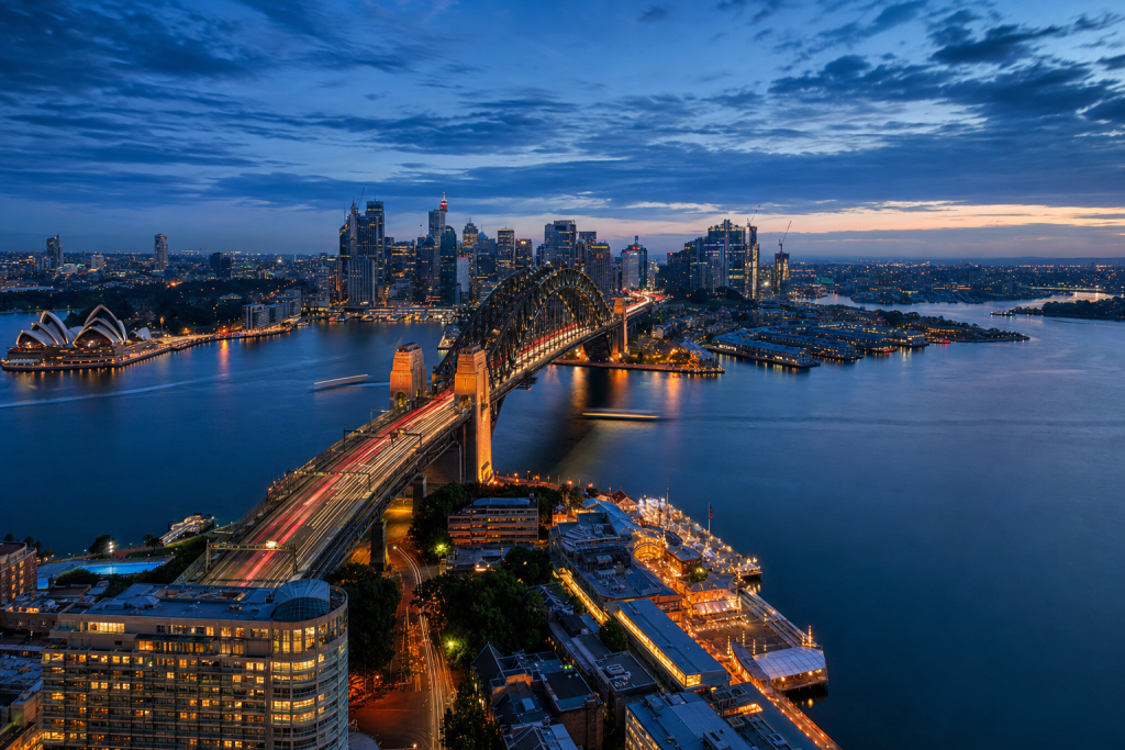 Sydney high-vantage cityscape at blue hour with city lights and traffic motion