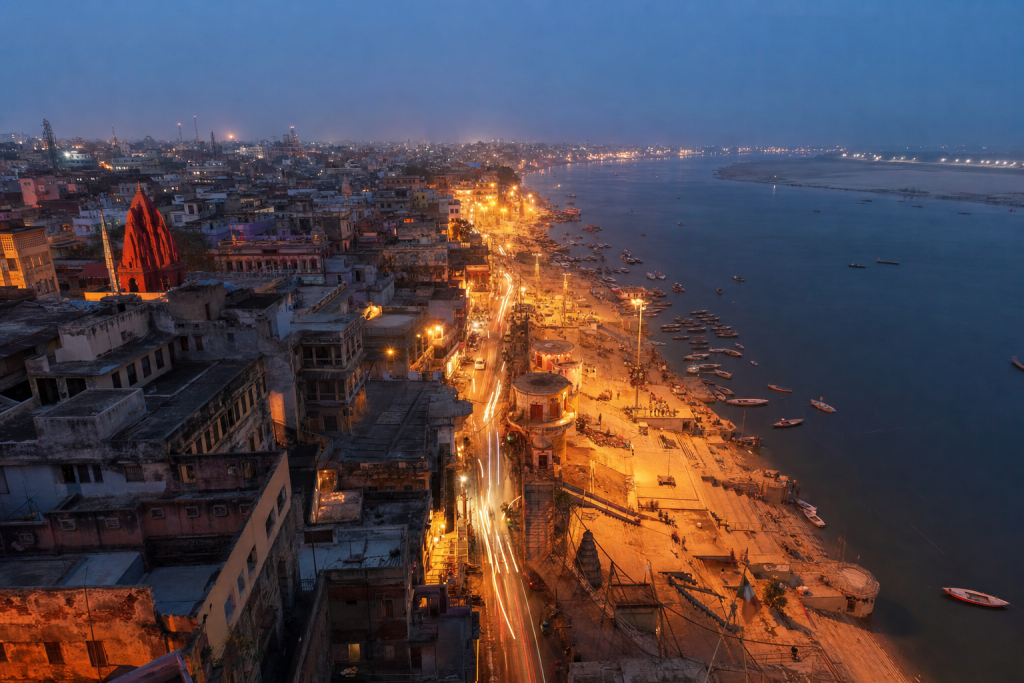 Varanasi high-vantage cityscape at blue hour with city lights and traffic motion