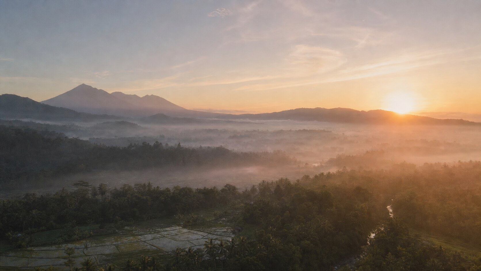Sunrise aerial-style view of Bali, the signature opening shot most photography tours begin with
