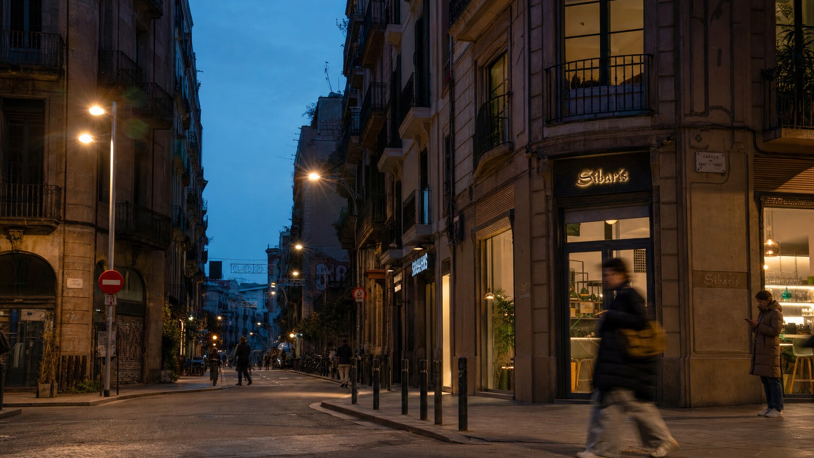 Blue hour street photography scene in Barcelona during a guided photography tour, showing the kind of low-light composition tour photographers cover