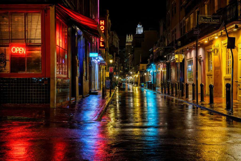 Night street scene with neon reflections on wet pavement, atmospheric mood