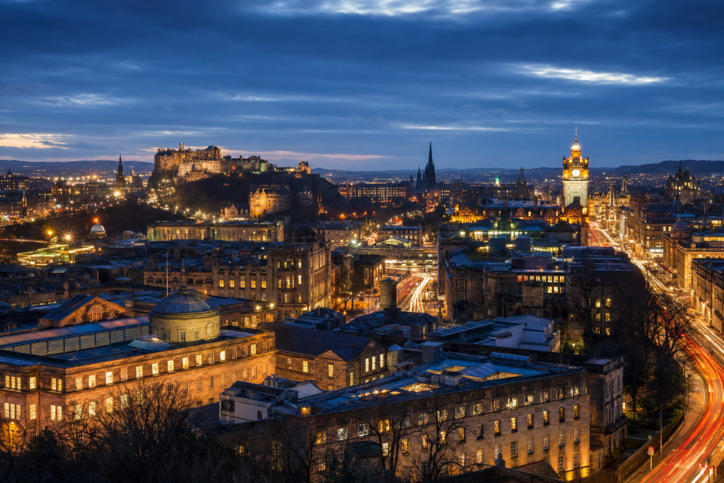 High-vantage view of Es Best Photography Spots in Edinburgh during blue hour, glowing city lights, subtle motion