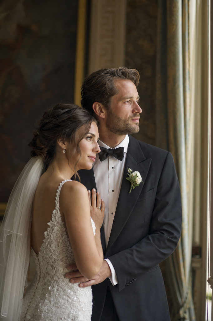 Soft window light, bride and groom in elegant attire, romantic mood
