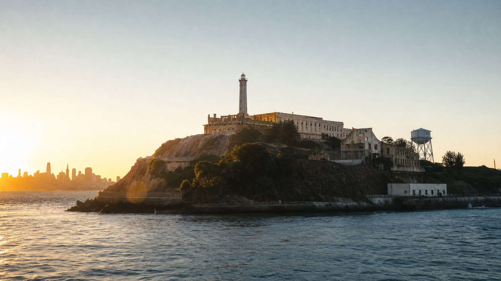 Alcatraz Island photographed at golden hour from the most popular hero-shot vantage point, with dramatic side-lighting on the structure