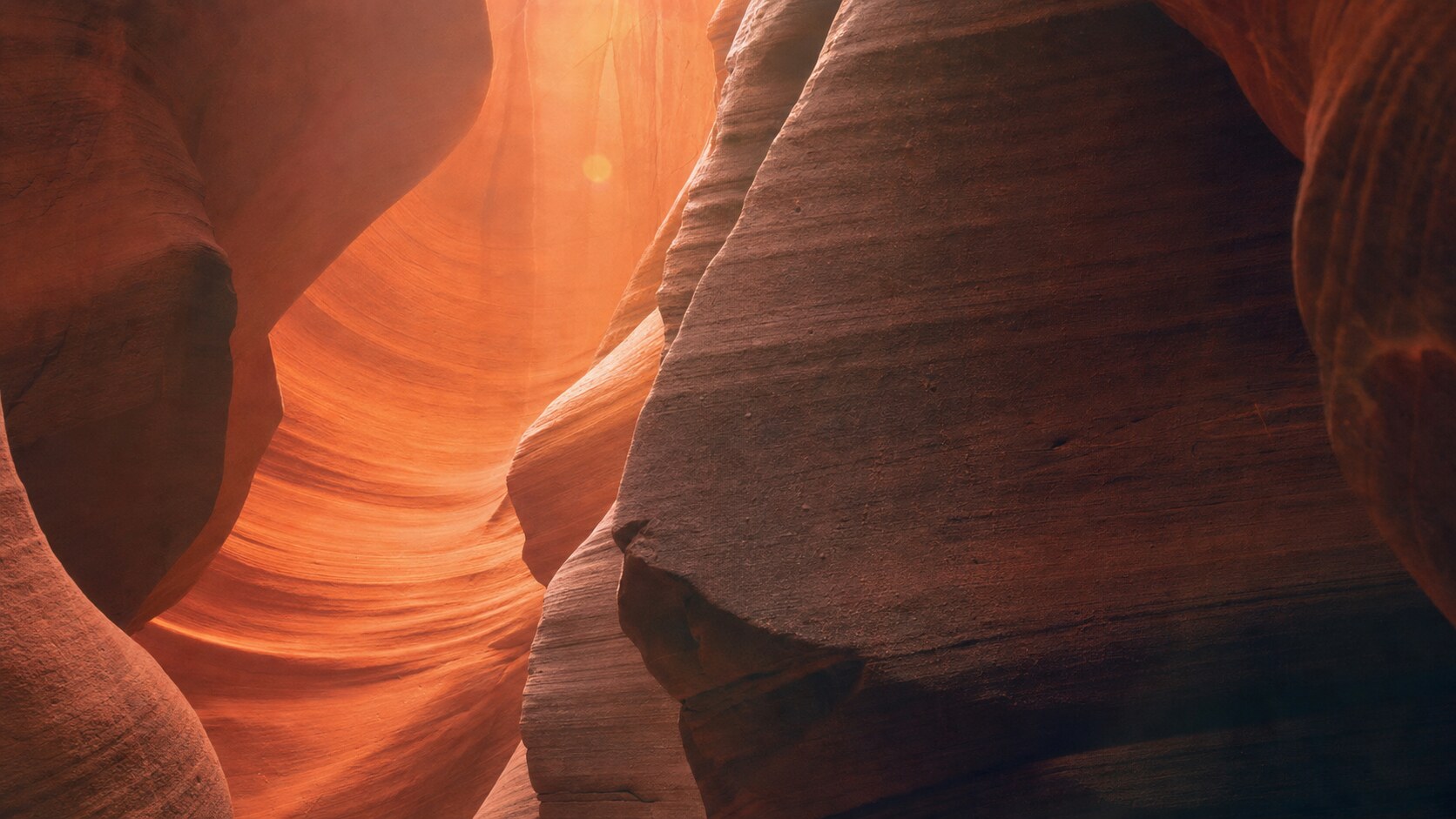 Close-up architectural detail of Antelope Canyon at late afternoon, showing surface texture and material under directional sun