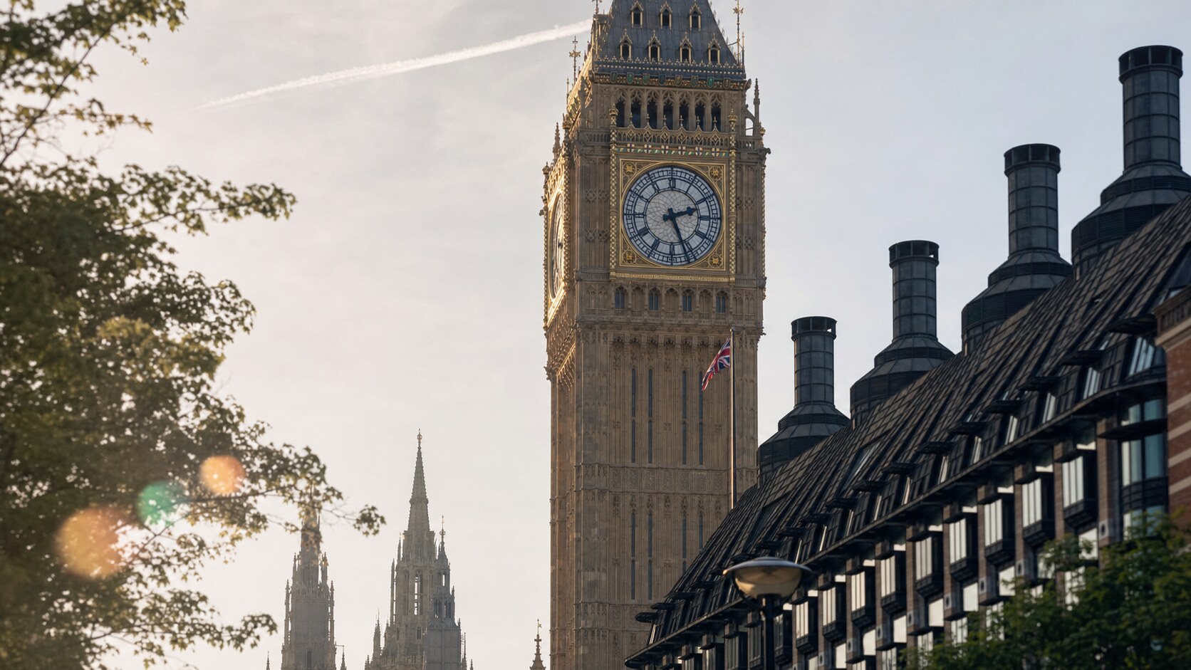 Close-up architectural detail of Big Ben London at late afternoon, showing surface texture and material under directional sun
