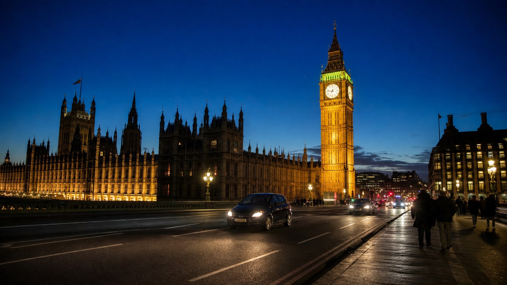 Wide blue-hour view of Big Ben London with cobalt sky and warm artificial lighting on the landmark