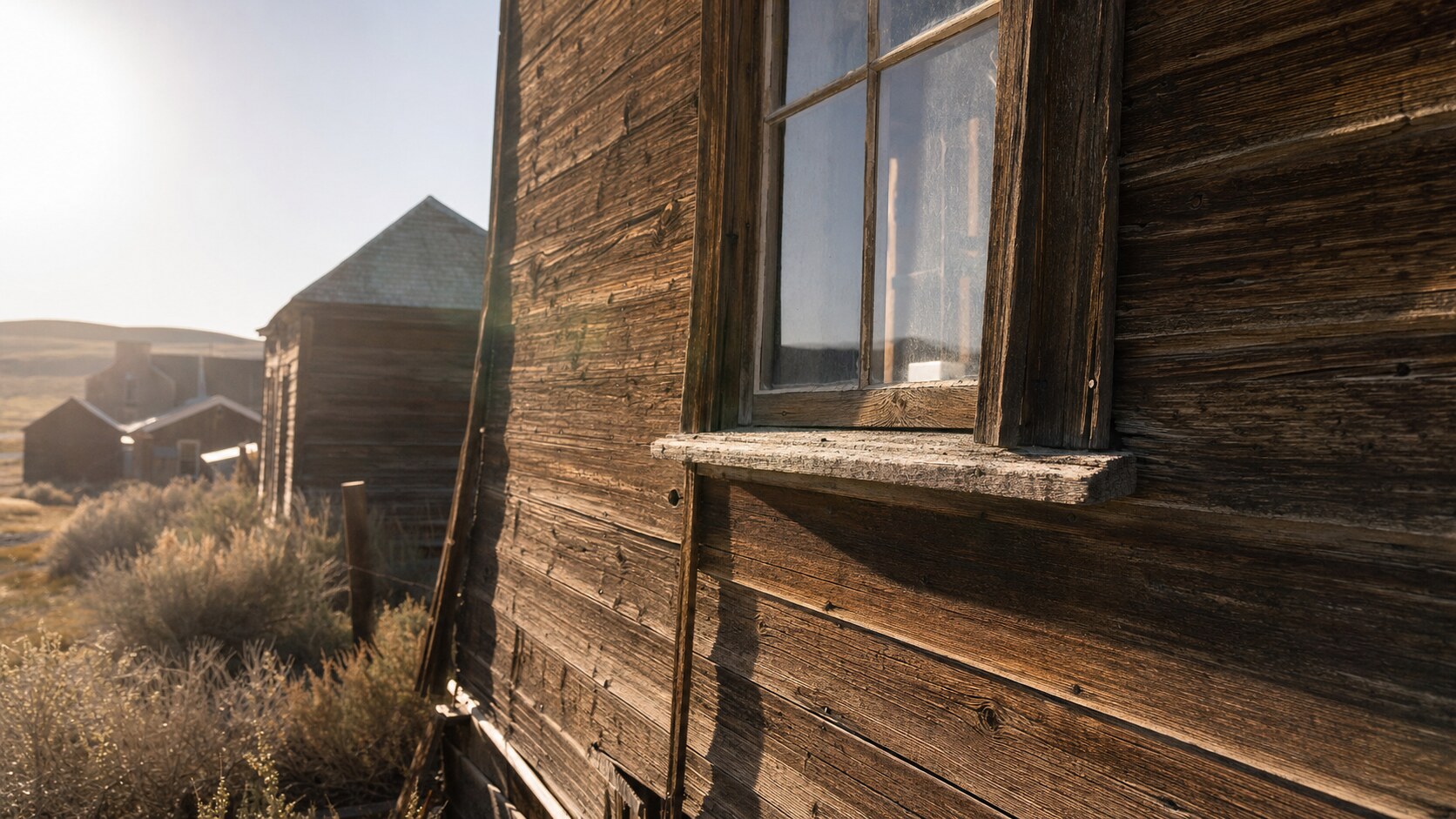 Close-up architectural detail of Bodie State Historic Park at late afternoon, showing surface texture and material under directional sun