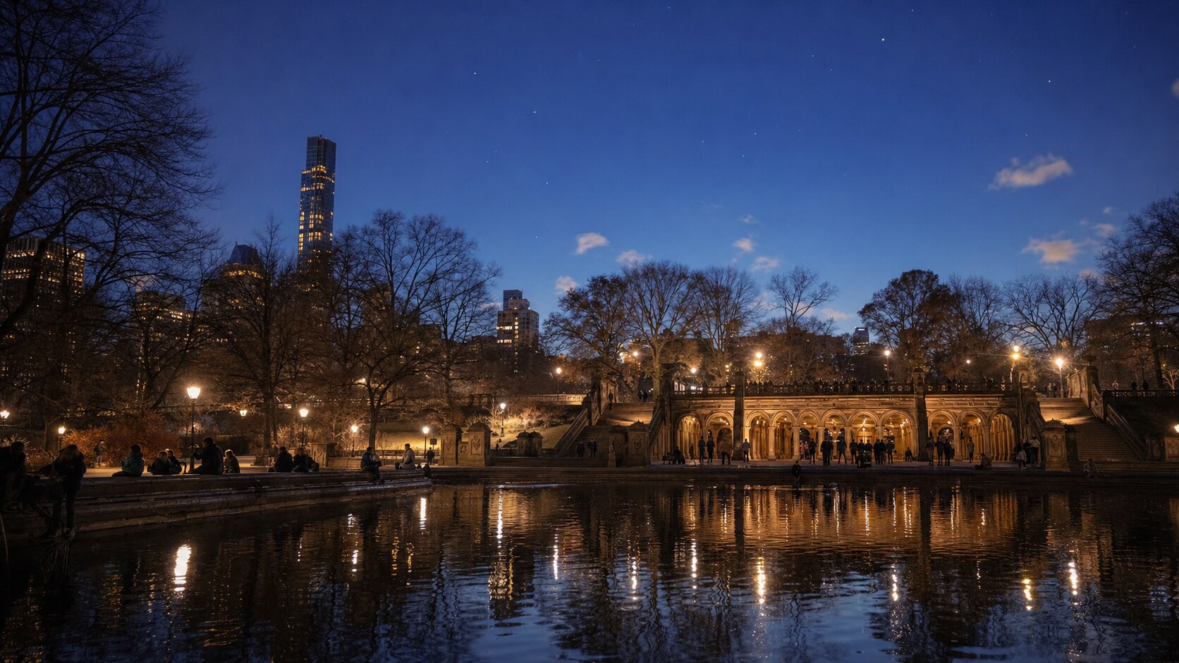Wide blue-hour view of Central Park with cobalt sky and warm artificial lighting on the landmark