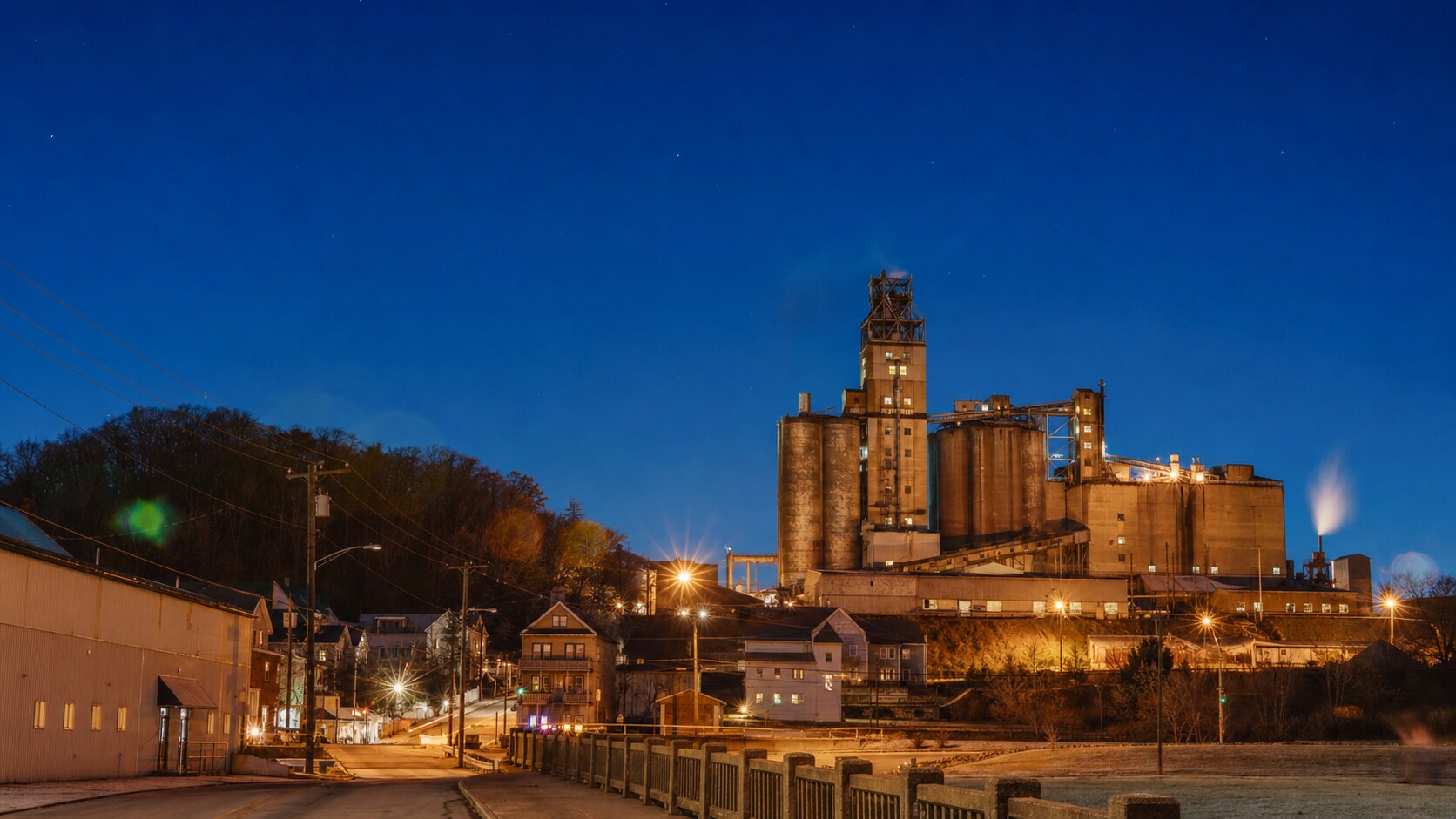 Wide blue-hour view of Centralia Pennsylvania with cobalt sky and warm artificial lighting on the landmark