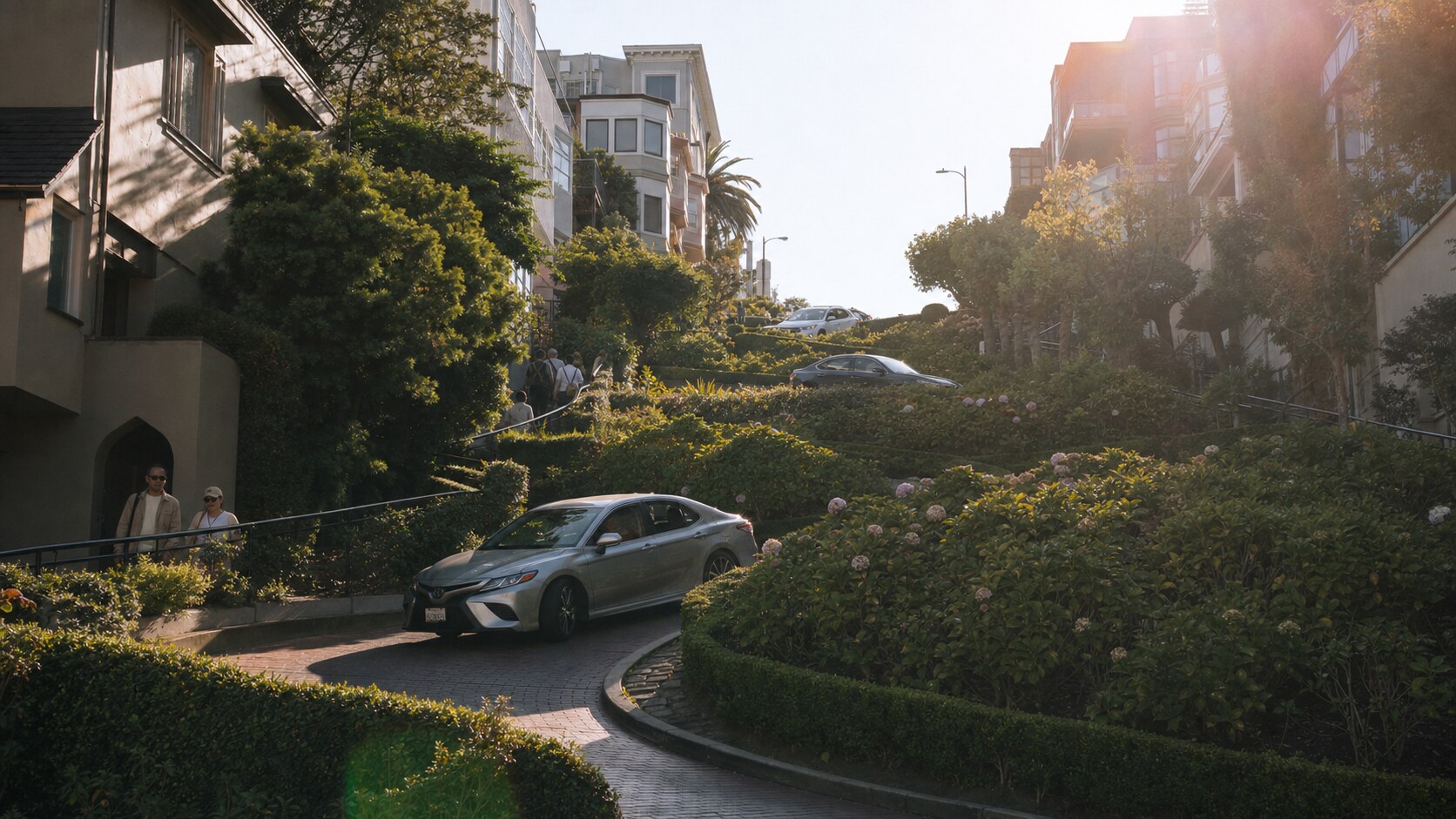 Close-up architectural detail of Lombard Street at late afternoon, showing surface texture and material under directional sun