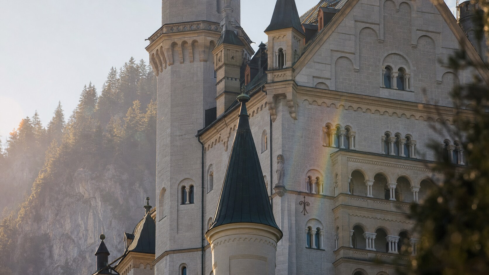 Close-up architectural detail of Neuschwanstein Castle at late afternoon, showing surface texture and material under directional sun