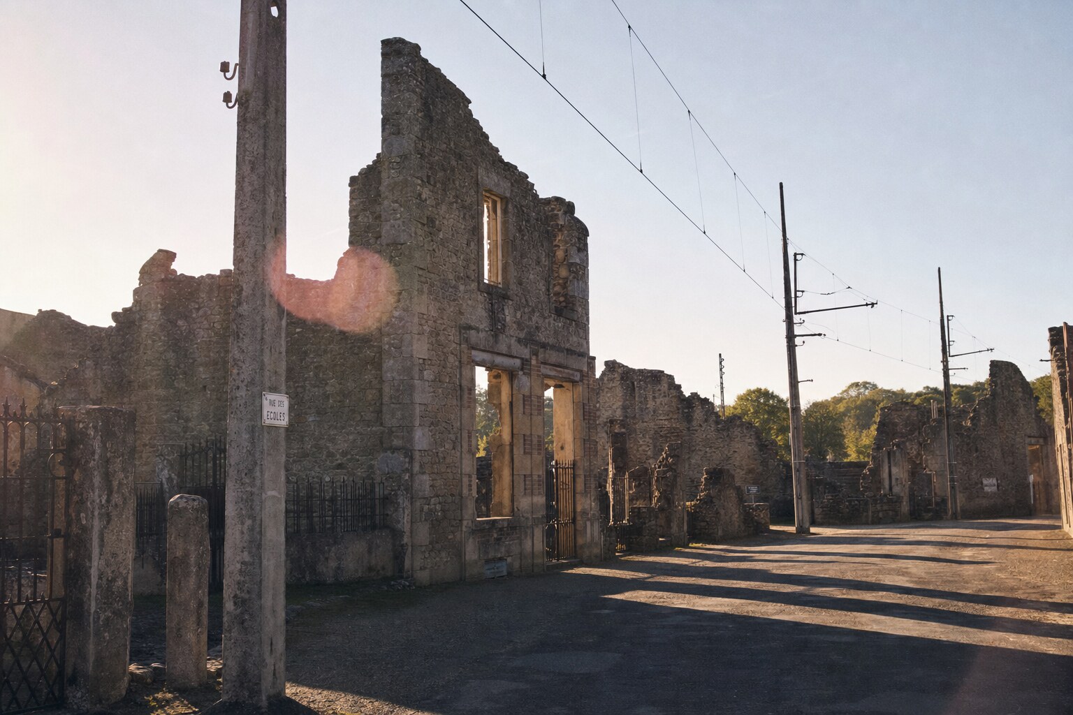Close-up architectural detail of Oradour Sur Glane at late afternoon, showing surface texture and material under directional sun