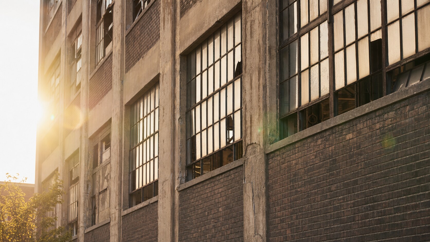 Close-up architectural detail of Packard Automotive Plant at late afternoon, showing surface texture and material under directional sun