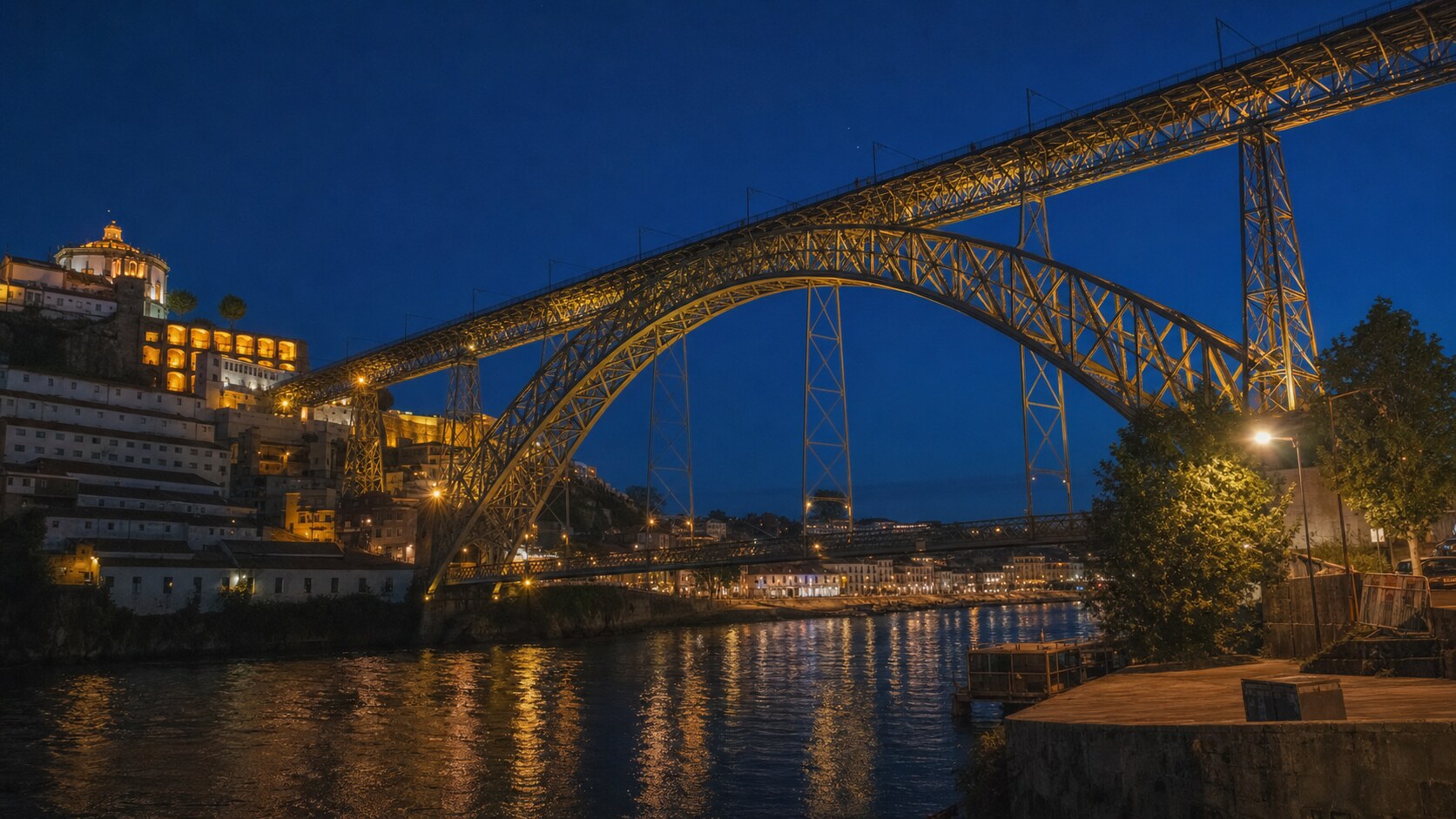 Wide blue-hour view of Ponte De Dom Luis with cobalt sky and warm artificial lighting on the landmark