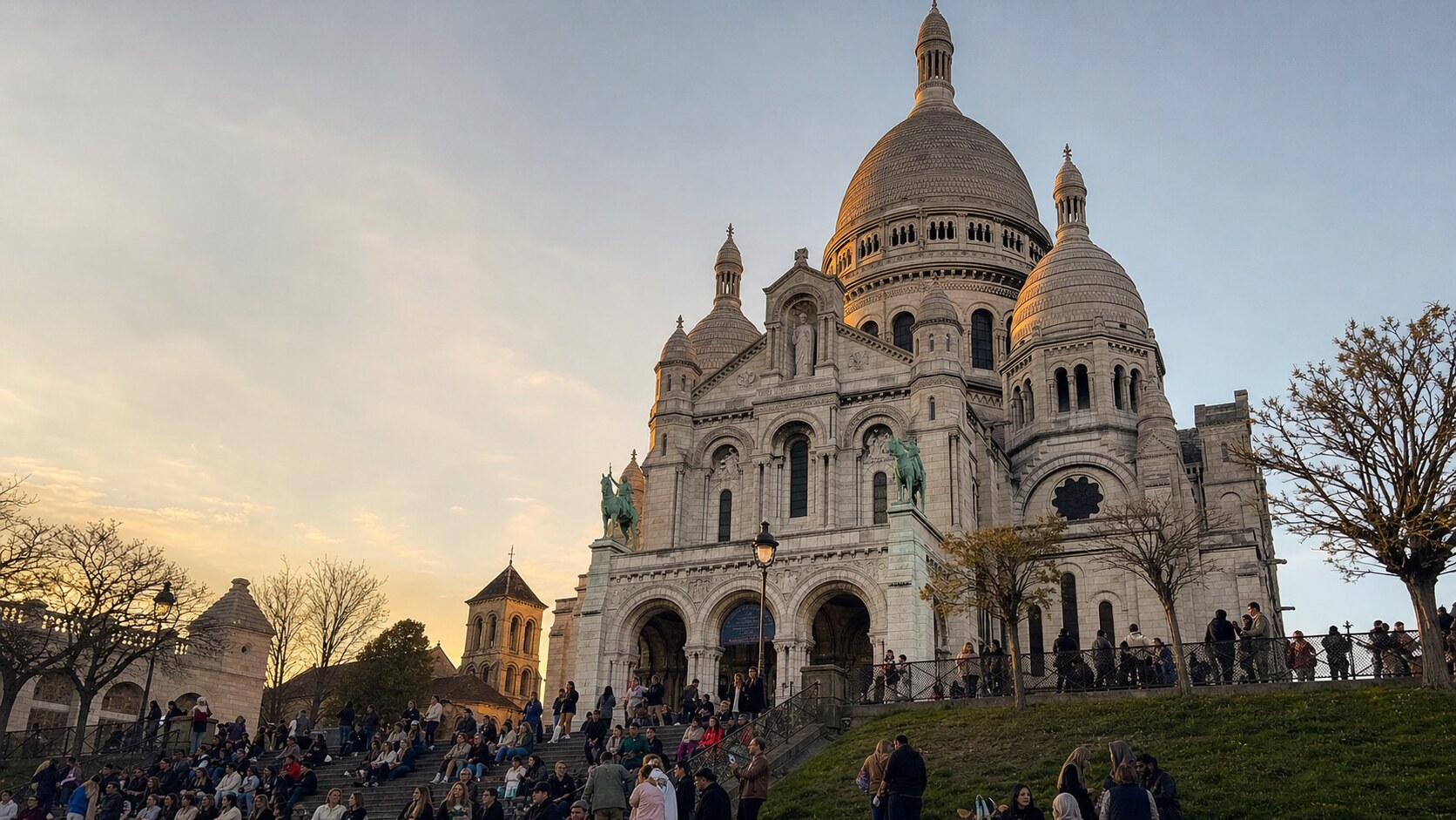 Sacre Coeur photographed at golden hour from the most popular hero-shot vantage point, with dramatic side-lighting on the structure