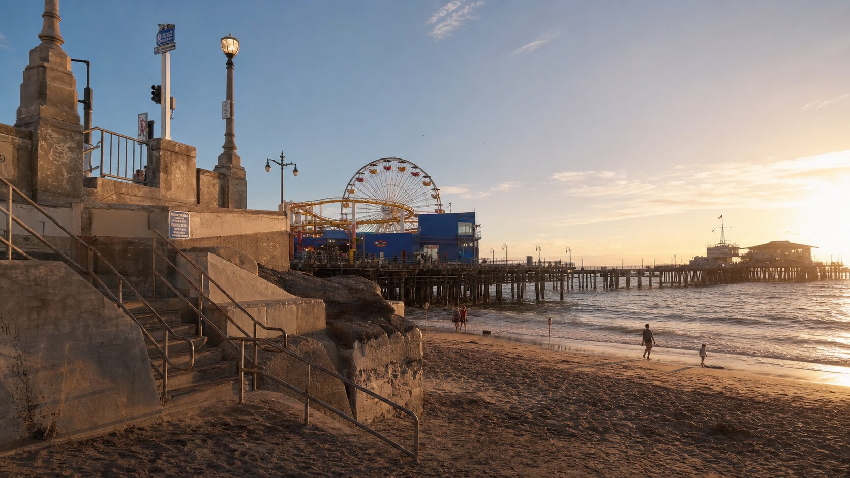 Santa Monica Pier photographed at golden hour from the most popular hero-shot vantage point, with dramatic side-lighting on the structure