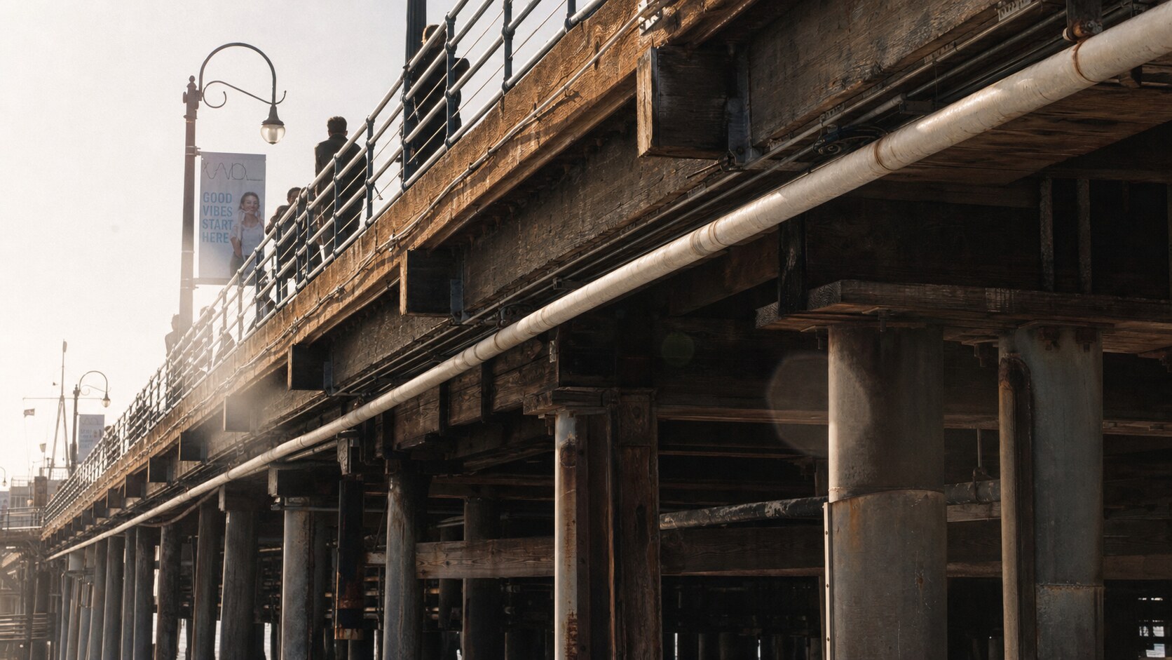 Close-up architectural detail of Santa Monica Pier at late afternoon, showing surface texture and material under directional sun
