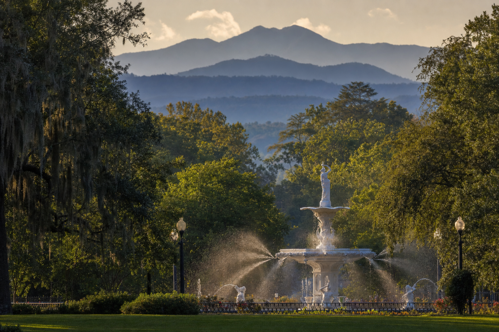 Telephoto compression shot of Savannah Forsyth Park, layered ridges and mountain detail, late-afternoon side light