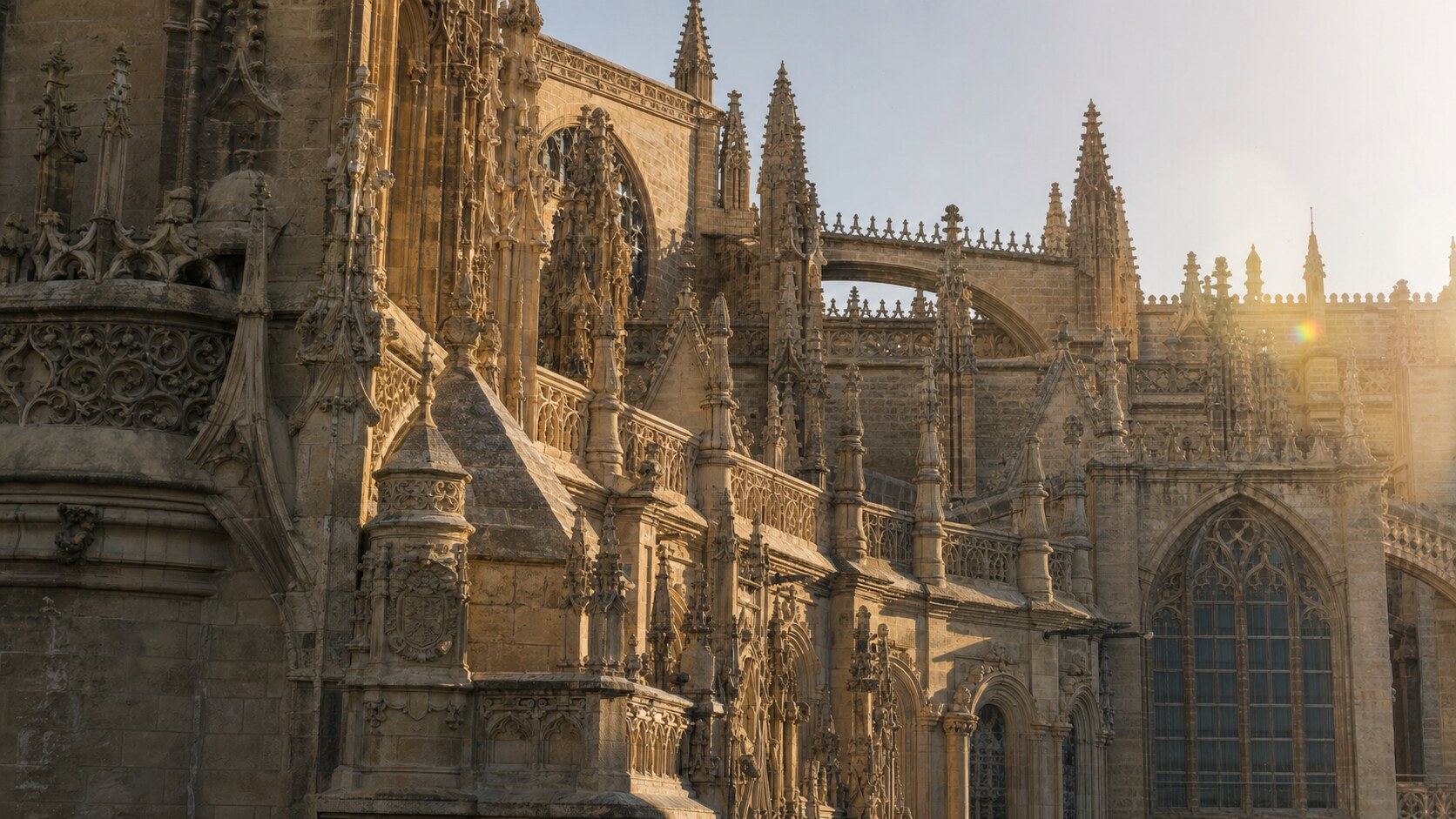 Close-up architectural detail of Seville Cathedral at late afternoon, showing surface texture and material under directional sun