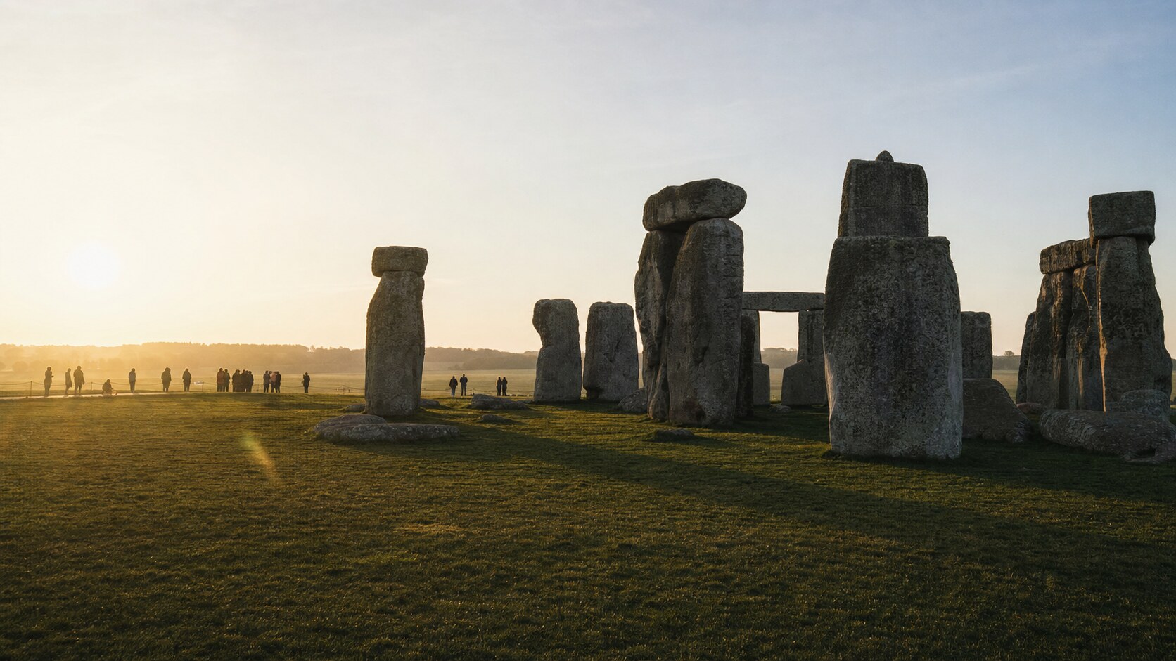 Stonehenge photographed at golden hour from the most popular hero-shot vantage point, with dramatic side-lighting on the structure