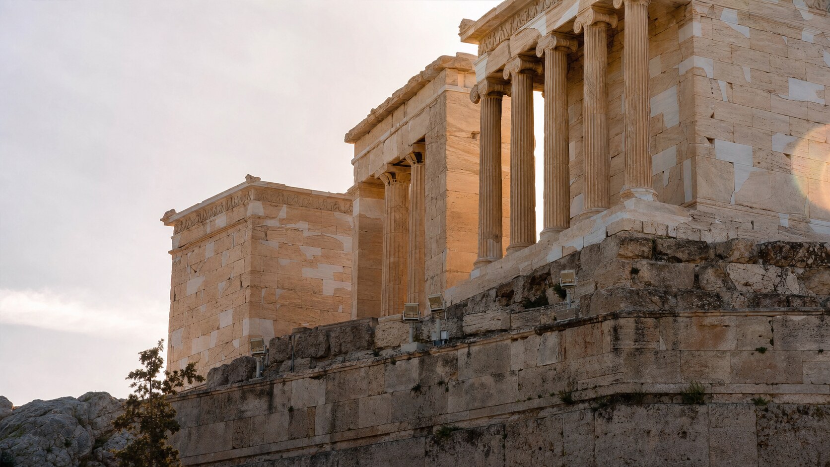Close-up architectural detail of The Acropolis at late afternoon, showing surface texture and material under directional sun