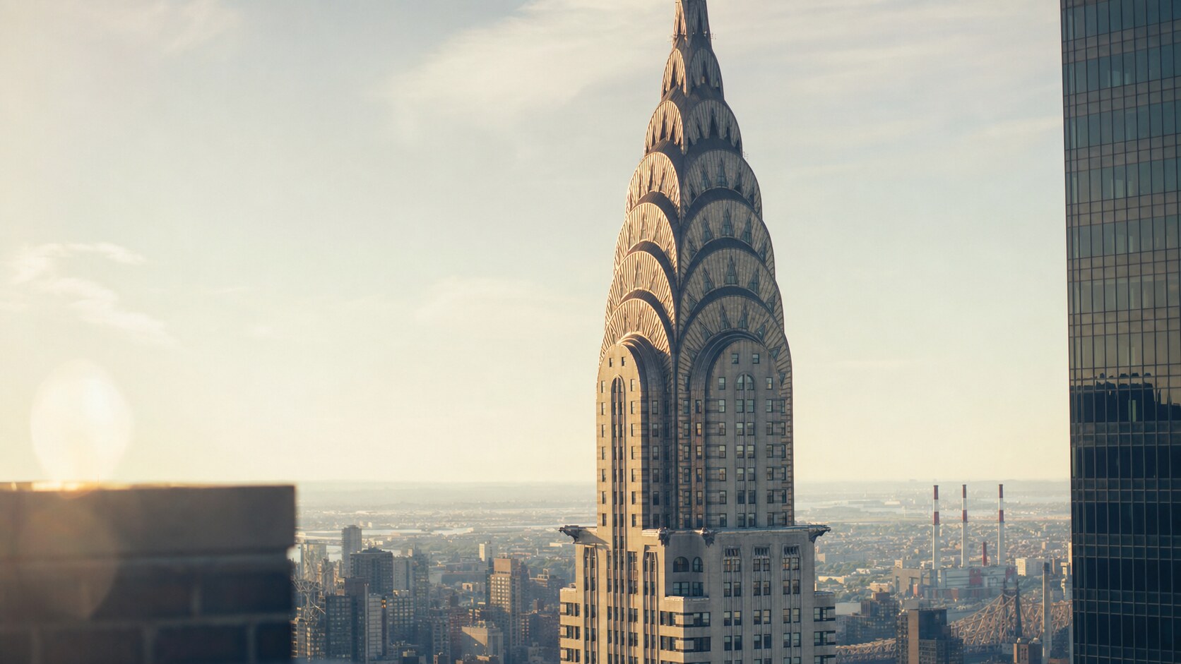 Close-up architectural detail of The Chrysler Building at late afternoon, showing surface texture and material under directional sun