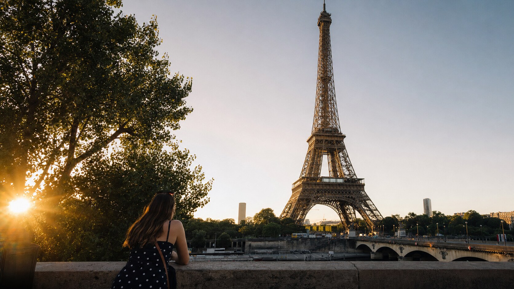 The Eiffel Tower Paris photographed at golden hour from the most popular hero-shot vantage point, with dramatic side-lighting on the structure