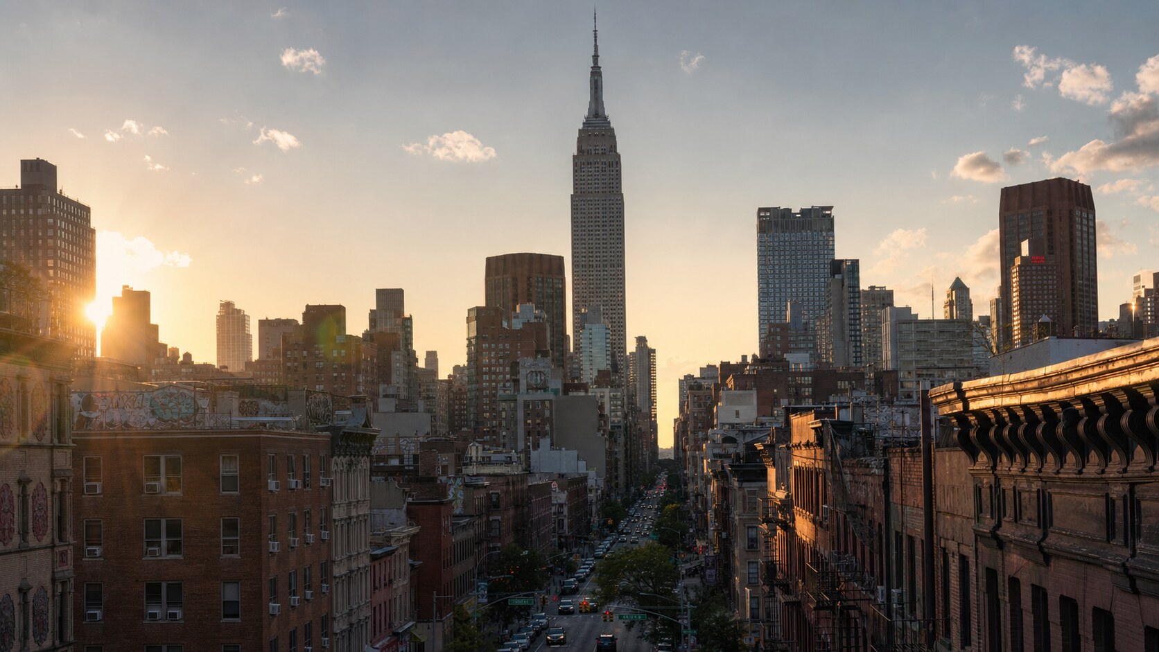 The Empire State Building photographed at golden hour from the most popular hero-shot vantage point, with dramatic side-lighting on the structure