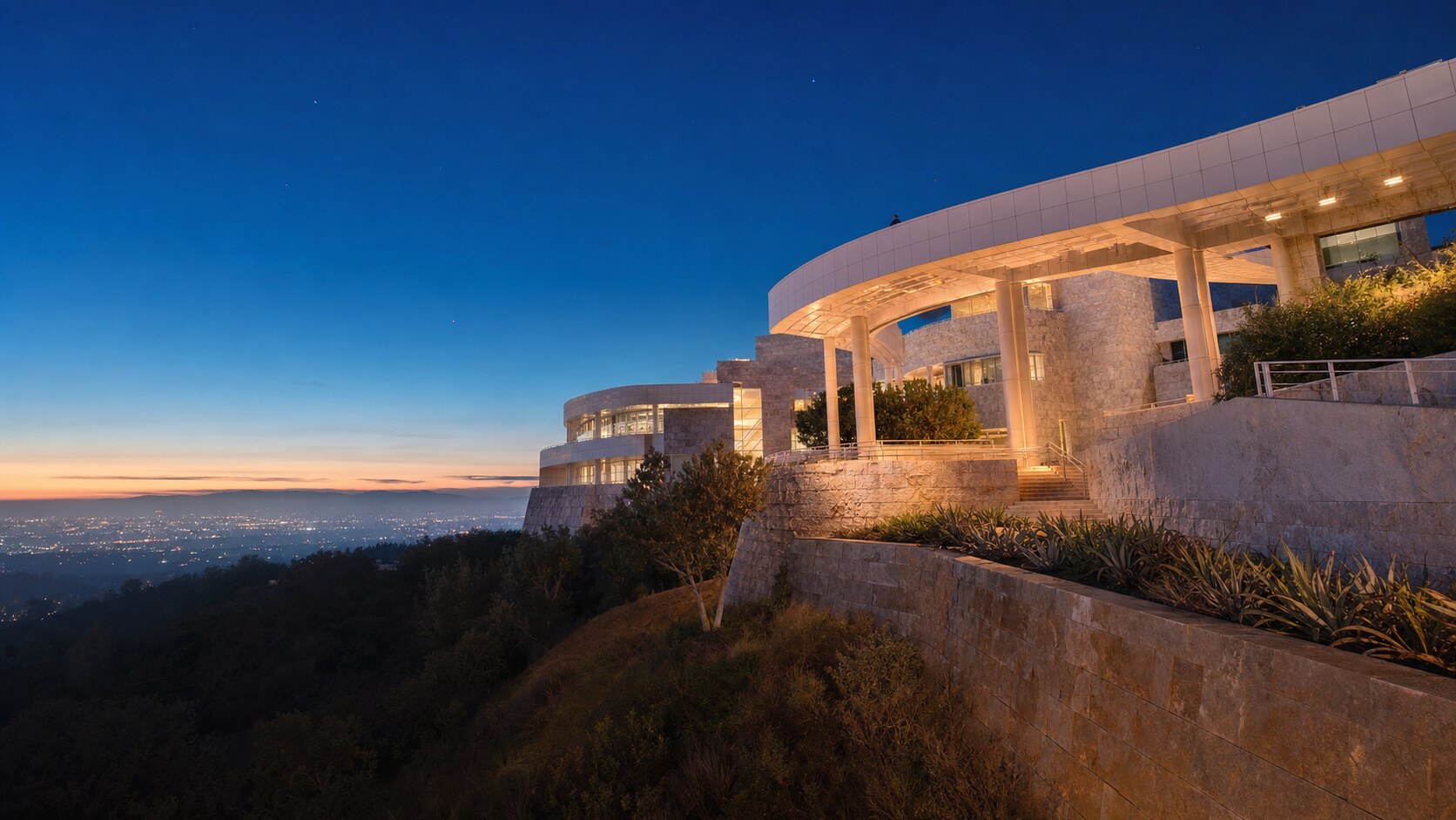 Wide blue-hour view of The Getty with cobalt sky and warm artificial lighting on the landmark