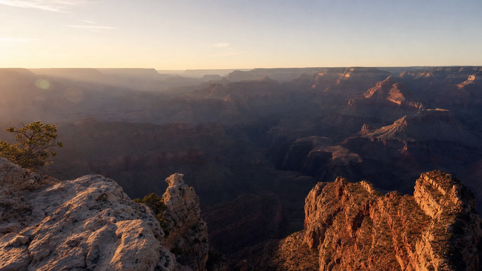 The Grand Canyon photographed at golden hour from the most popular hero-shot vantage point, with dramatic side-lighting on the structure